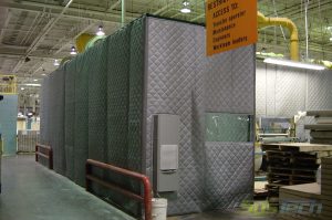 Loud machinery is isolated by encapsulating it with noise blankets attached with Velcro closures to a framework structure. These enclosures are constructed with viewing windows, access panels, man doors, or overhead panels for crane access.