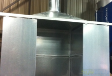 Custom galvanized fume hood designed with doors sliding on tracks to open and shut as the melting process is engaged.